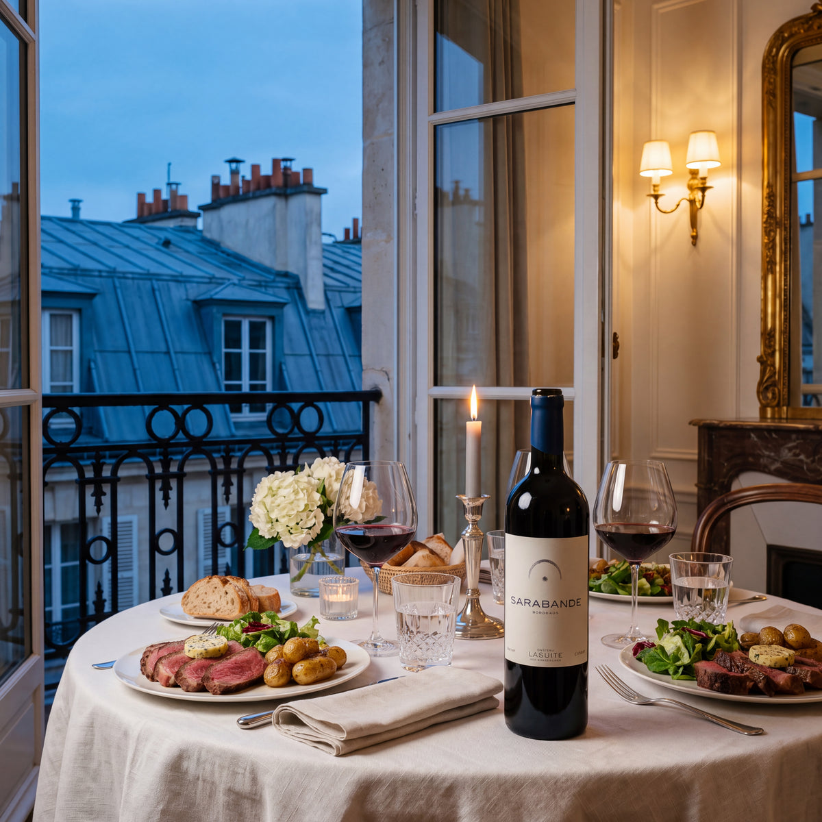 Sarabande 2015, Bordeaux red wine – bottle on a laid table by an open window, Paris rooftops in the evening